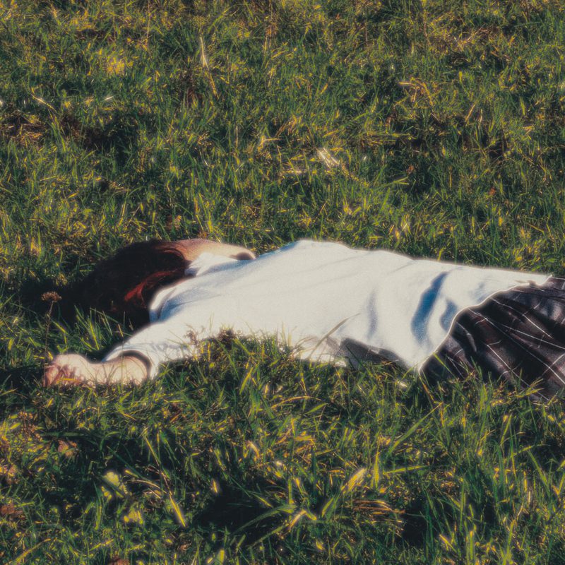 Decompose cover: mollywater lying face down in long grass