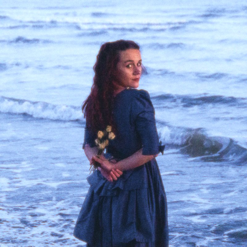 Tea & Toast cover: mollywater standing in the sea holding flowers